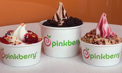 Three delicious cups of Pinkberry frozen yogurt with, from left to right, strawberries, chocolate cookies, and granola toppings.
