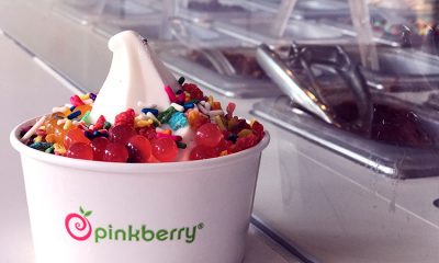 A delicious cup of Pinkberry frozen yogurt with rainbow sprinkles and bright, pink boba balls.